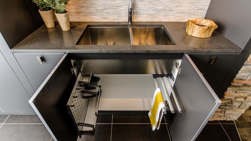 Storage designed by Ateliers Jacob for cabinets below the sink