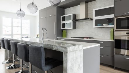 Contemporary Kitchen with central island and built-in cupboards.