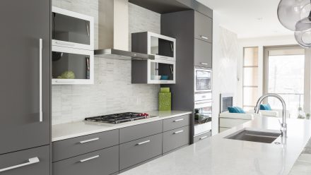 Modern Kitchen with central island and white worktop.
