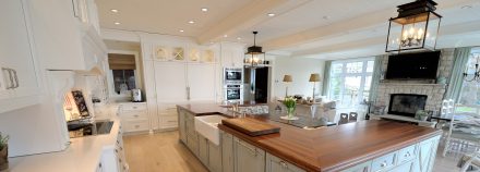 Rustic Kitchen with central island and white cabinets.