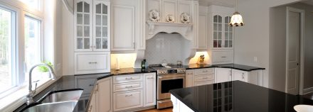 Rustic Kitchen with central island and white cabinets.