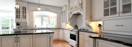 Rustic Kitchen with a central island and white cabinets.