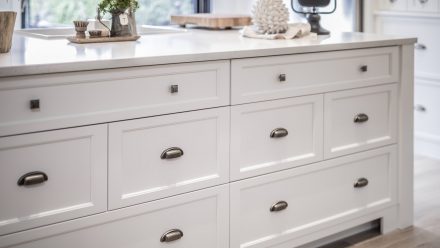 Natural colored Kitchen with central island and rustic cabinets.