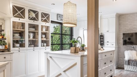 Country-style Kitchen with central island and white cabinets.