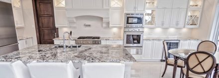 Classic Kitchen with central island and white cabinets.