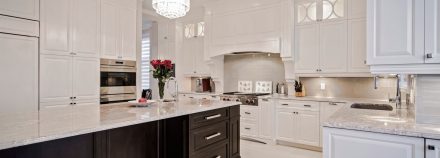 Spacious kitchen with central island and integrated storage.