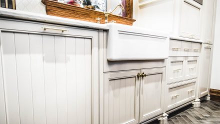 Elegant Kitchen with white cabinets and light countertops.