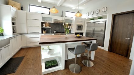 Stylish Kitchen with integrated cabinets and white central island.