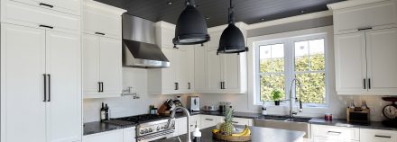 Furnished kitchen with contemporary lines and dark counter.