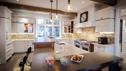 Spacious kitchen with wooden central island and modern appliances.