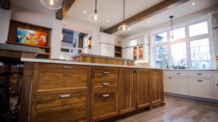 Spacious kitchen with open cabinets and central island.