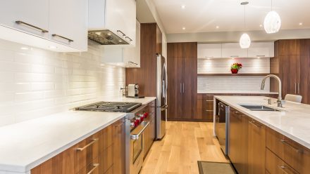 Dark kitchen with central island and wall shelves in a modern interior.