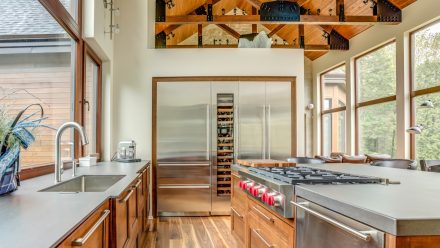 Spacious kitchen with central island and built-in refrigerators.