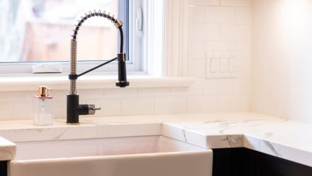 Modern kitchen with central island and undermount sink.