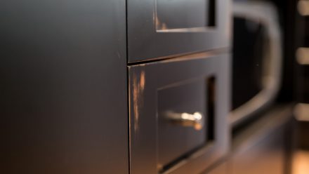 Furnished kitchen with dark cabinets in a modern style.