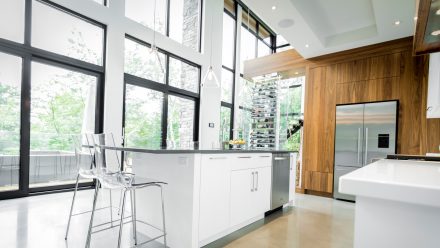 Sleek Kitchen with white cabinets and pantry space.