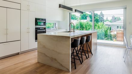 White kitchen with spacious central island.