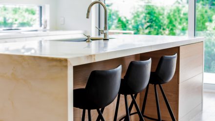 Contemporary style Kitchen with central island, dining area, and stone counter.