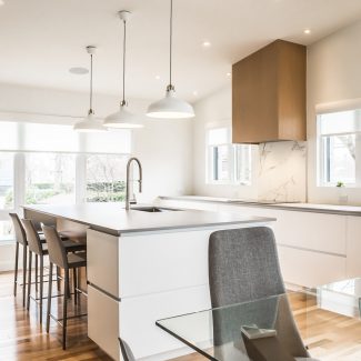 High-end Kitchen in a contemporary style with suspended lighting.