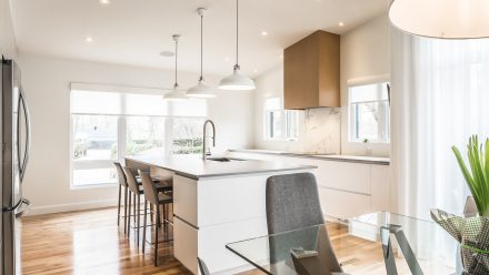 High-end Kitchen in a contemporary style with suspended lighting.