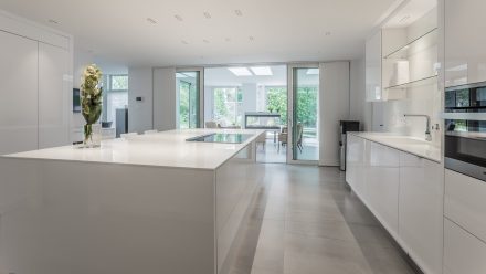 Modern Kitchen with central island, built-in appliances and designer lighting.