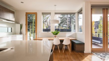 Kitchen with a dining area with a table, a bench seat and a few chairs.