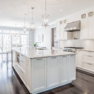 Kitchen with white cabinets in a modern and spacious space.