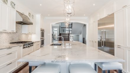 White kitchen with light-colored worktops and dining area.