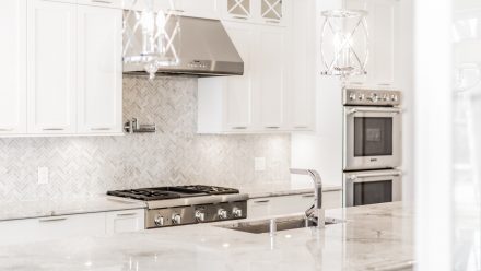 Spacious kitchen with elegant light-colored countertops.