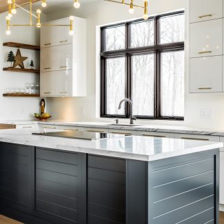 Spacious kitchen with white cabinets and matte black central island.