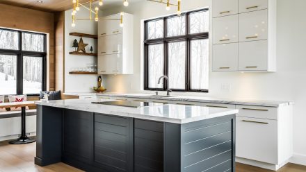 Spacious kitchen with white cabinets and matte black central island.