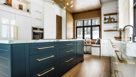 Spacious kitchen with soft lighting and elegant furniture in neutral tones.