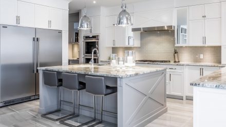 Modern Kitchen with central island and stone countertop.