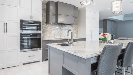 Kitchen fitted with cabinets, drawers, and central island, contemporary, functional and elegant.