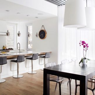 White kitchen with central island, storage cabinets, and spacious worktop.