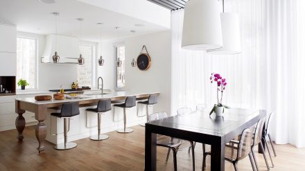 White kitchen with central island, storage cabinets, and spacious worktop.