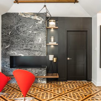 Modern design of a wall-mounted fireplace framed in a gray wall.