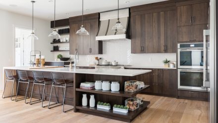 Modern Kitchen with central island and light-colored countertop.