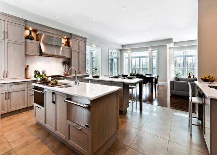 Modern kitchen furniture with dark cabinets and shelves.