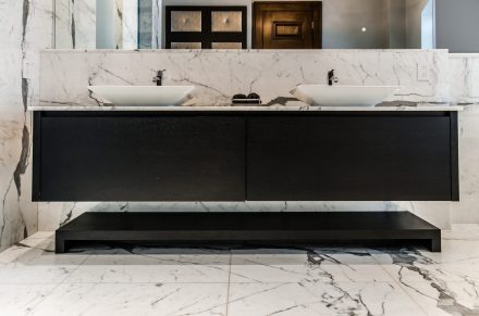 Dark bathroom with elegant storage.