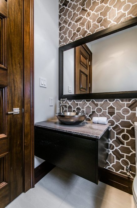 Bright atmosphere in this modern bathroom with well-arranged countertop and cabinets.