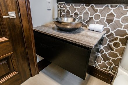 Bright atmosphere in this modern bathroom with well-arranged countertop and cabinets.