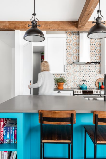 White kitchen cabinets with dark stone countertop.