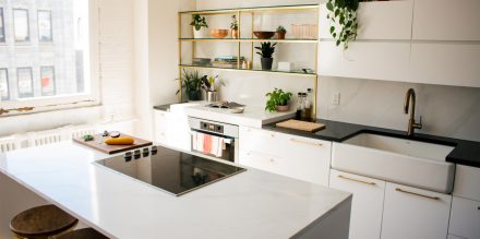 Spacious and streamlined white kitchen equipped with modern appliances.