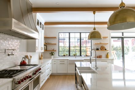 Modern Kitchen with dark island and designer lighting.