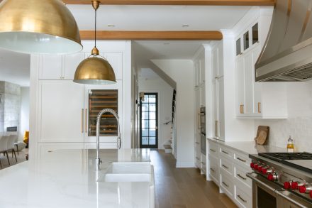 Modern Kitchen with dark island and designer lighting.