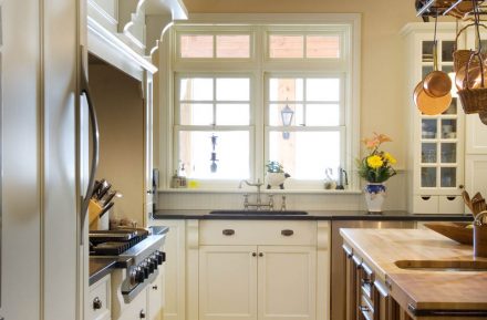 Classic Kitchen with island and white cabinets in a Cape Cod style house.