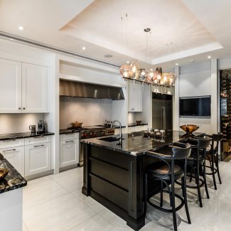 Modern Kitchen with neutral tones featuring a central island and natural stone countertop.