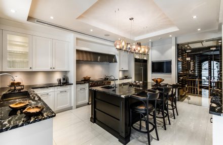 Modern Kitchen with neutral tones featuring a central island and natural stone countertop.