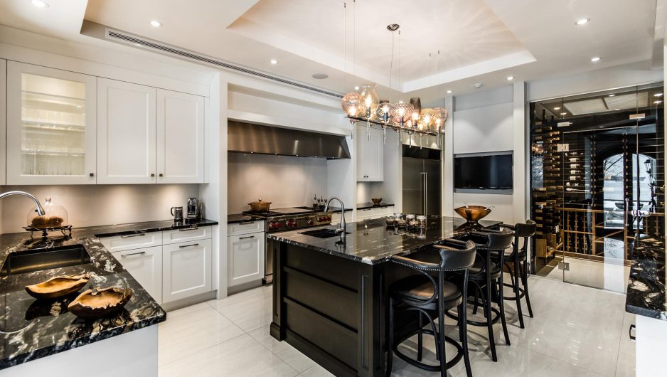 Modern Kitchen with neutral tones featuring a central island and natural stone countertop.